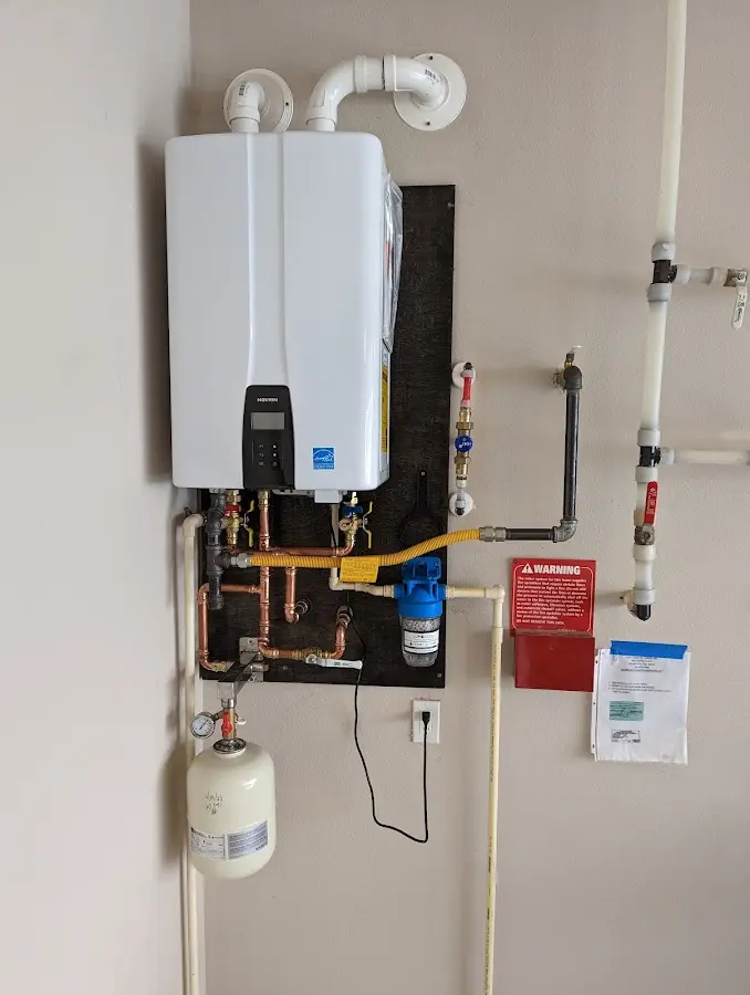 Professional plumber installing copper piping in a Schiller Park home